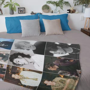May include: A blanket featuring a collage of images of a person in various poses and outfits. The blanket is laid out on a bed with blue and beige pillows. The bed is covered with a gray sheet.