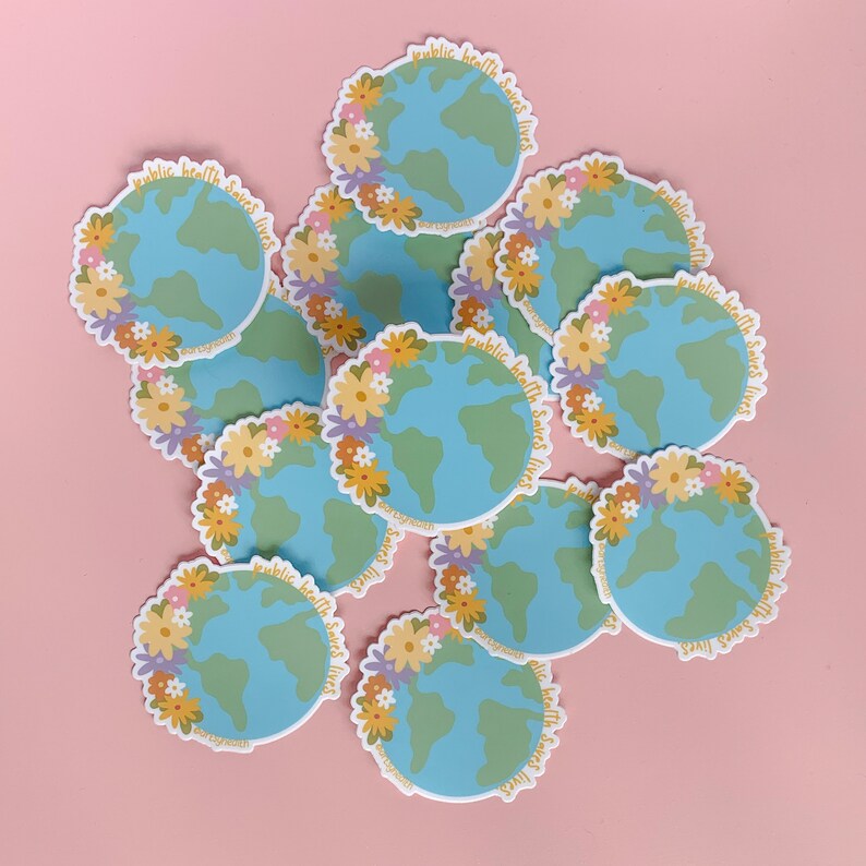 May include: A pile of colorful stickers with a blue and green globe design. The stickers have a floral border and the text "public health saves lives" around the globe.