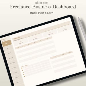 May include: A digital tablet displaying a freelance business dashboard. The screen shows a beige and white interface with sections for tracking income, expenses, and clients. Text on the screen includes "Freelance Business Dashboard" and "Track, Plan & Earn."