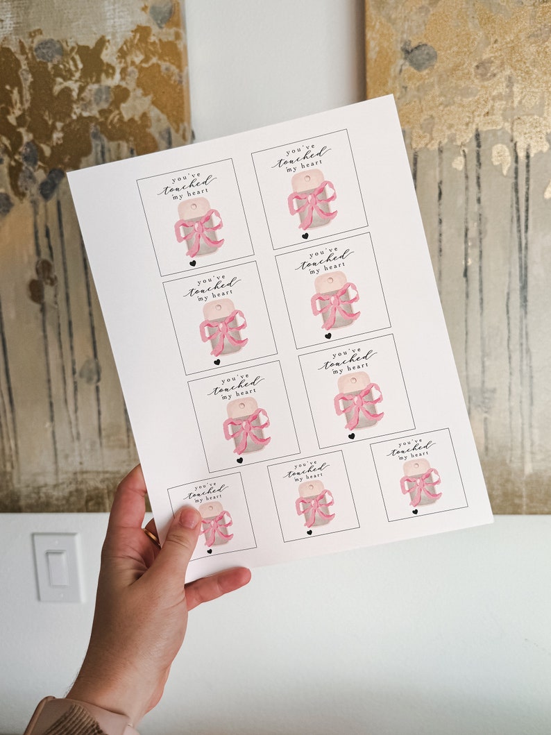 May include: Printable sheet of eight gift tags with a pink bow and the text "You've touched my heart".