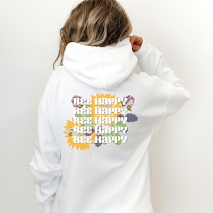 May include: White hoodie with a graphic of sunflowers and bees on the back. The graphic says "Bee Happy" five times.