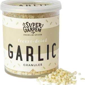 May include: A clear plastic jar filled with freeze-dried garlic granules. The jar has a white label with the text "Super Garden Premium Spices freeze-dried Garlic Granules".