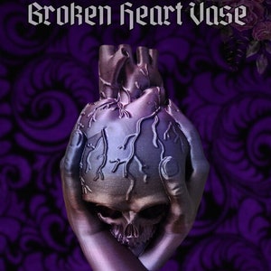 May include: A 3D printed vase shaped like a human heart held by two hands. The heart is a dark purple colour with a skull inside. The background is a dark purple with a swirling pattern.