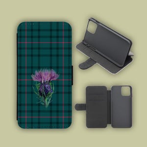 May include: A mobile phone case featuring a green and black tartan design, with a purple thistle motif. The case is shown open, displaying the phone's interior and a separate phone holder.