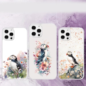 May include: Three phone cases featuring watercolour designs of puffins and flowers. The cases are white with a clear background and have a black camera lens cutout.