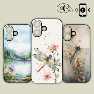 Puede incluir: Tres fundas para teléfono con diseños de libélulas. Una funda presenta un paisaje de acuarela con una libélula sobre un lago. Otra tiene una libélula con flores rosas. La tercera funda tiene una libélula con flores.