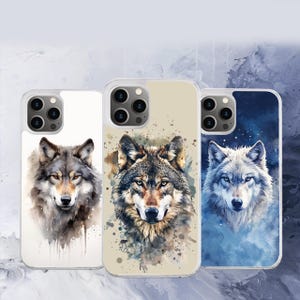 May include: Three iPhone cases with watercolor wolf designs. The first case has a white background with a gray wolf. The second case has a beige background with a brown wolf. The third case has a blue background with a white wolf.