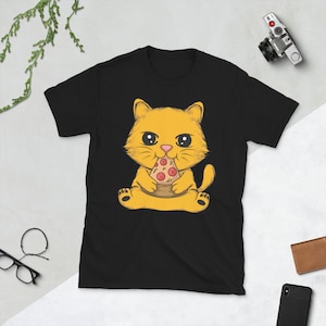 May include: Black t-shirt featuring a cartoon cat eating pizza. The cat is yellow with big eyes and is sitting down. The pizza slice has red pepperoni. The shirt is made of a soft material.