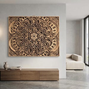 May include: A large, intricately carved wooden wall art piece with a mandala design. The artwork features multiple layers, creating a 3D effect. The piece is framed and mounted on a light-colored wall, showcasing the natural wood tones.