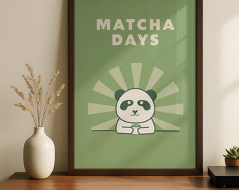 May include: A framed poster with a green background and the words "Matcha Days" in white. The poster features a cartoon panda holding a cup, with a sunburst design behind it. The frame is dark brown.