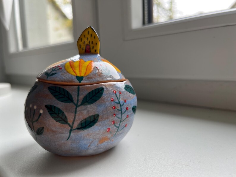 Light Blue Round Keepsake Box With Yellow Flowers and a Tiny House
