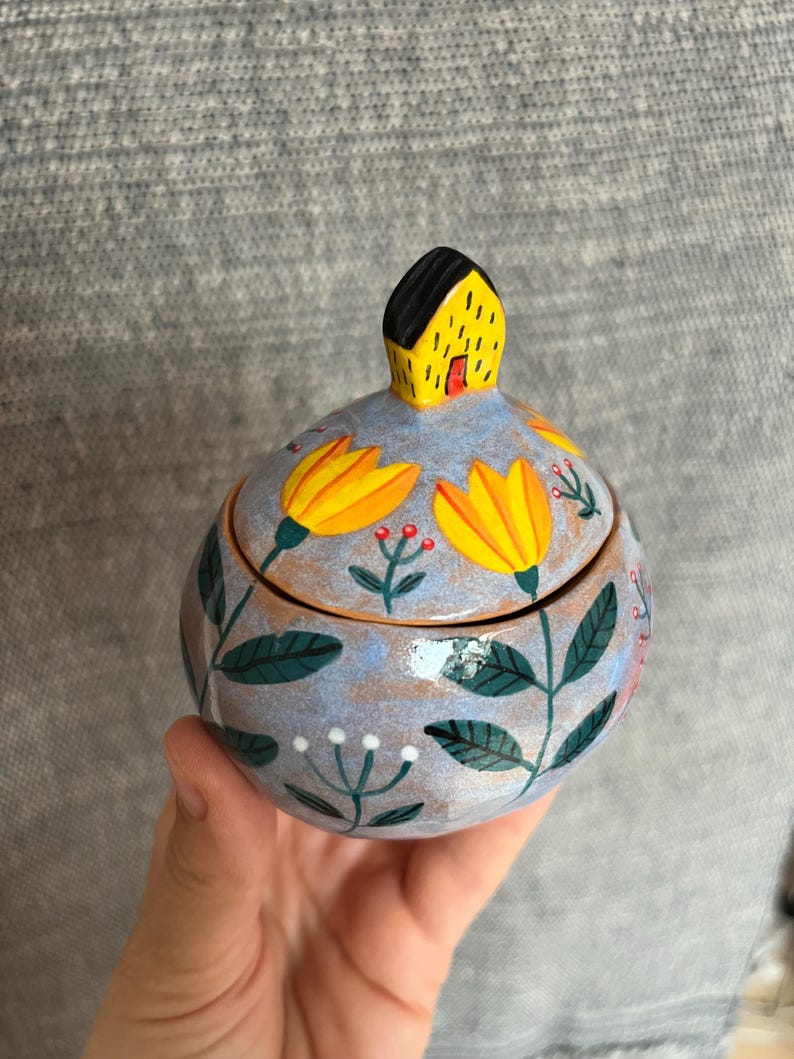 Light Blue Round Keepsake Box With Yellow Flowers and a Tiny House