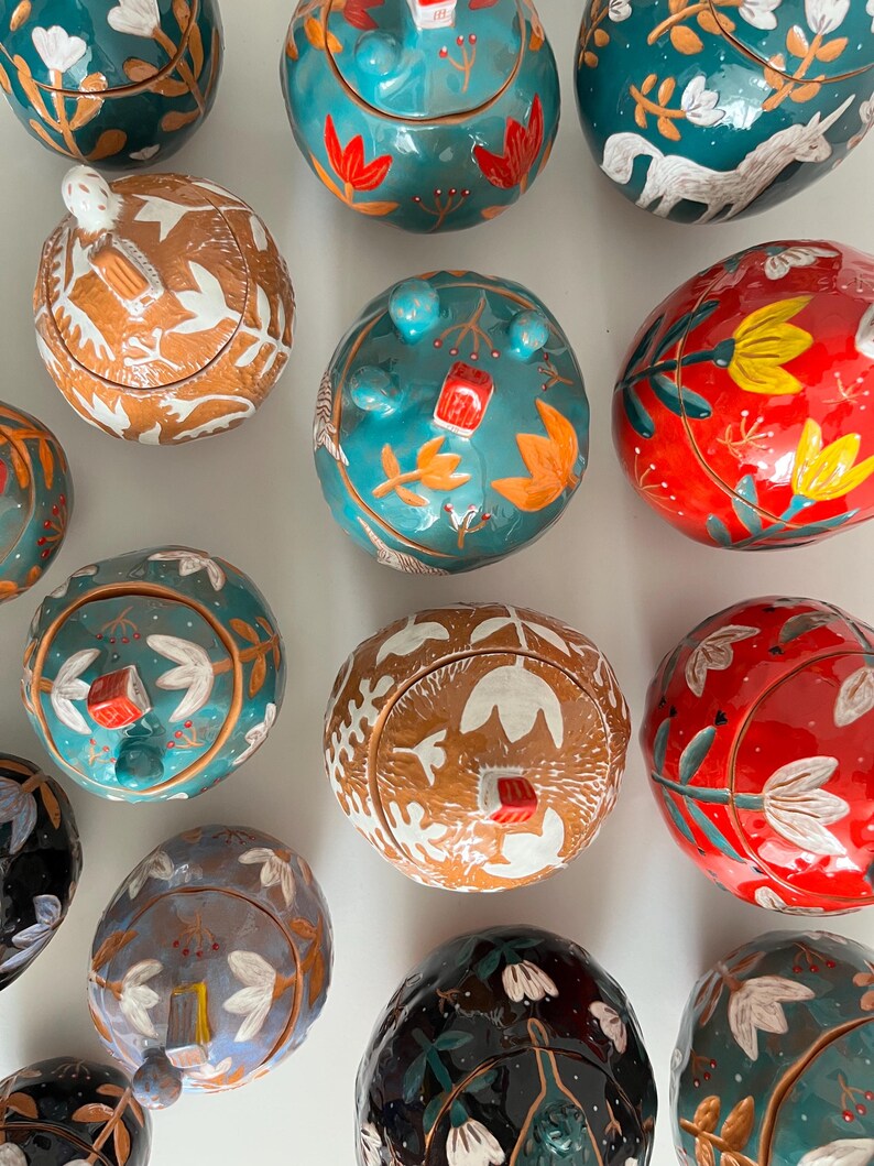 Light Blue Round Keepsake Box With Yellow Flowers and a Tiny House