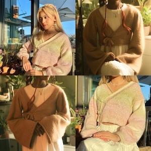 May include: Four different models wearing a pink and yellow ombre knit sweater with long sleeves and a wrap style neckline. The sweater is cropped and has a relaxed fit.