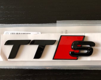 May include: Black and red "TTS" emblem with a black "S" in a red square.