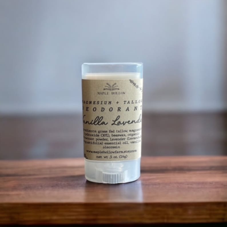 May include: A white plastic tube with a brown label that reads "Magnesium + Tallow Deodorant Vanilla Lavender" and "net wt 5 oz. (14g)".