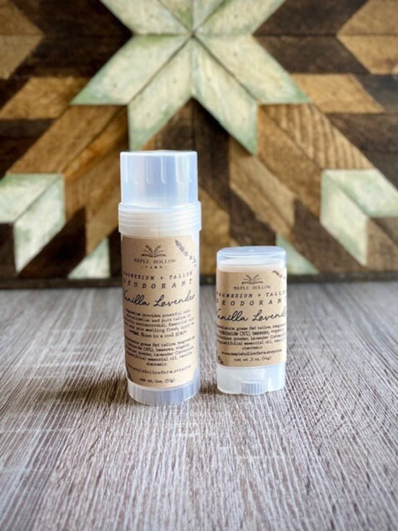 May include: Two natural deodorant sticks in clear plastic containers with brown labels. The larger stick is labeled "Magnesium + Tallow Deodorant Vanilla Lavender" and the smaller stick is labeled "Magnesium + Tallow Deodorant Vanilla Lavender".
