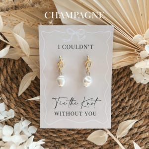 Pearl bridesmaid proposal earrings displayed on a champagne coloured proposal card, elegant wedding bridesmaid gift for maid of honour or bridal party proposal with a soft neutral aesthetic