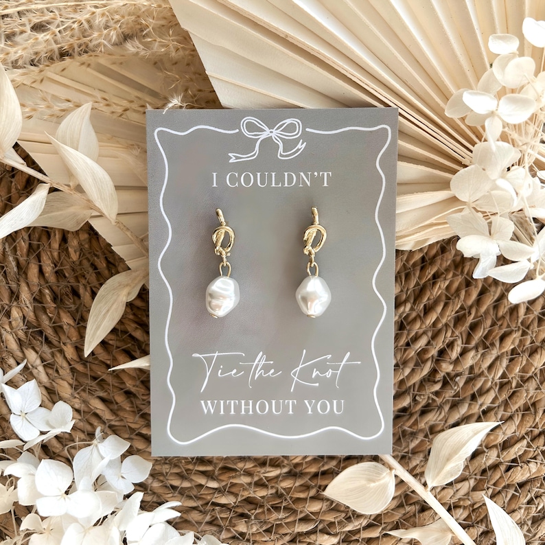 Pearl bridesmaid proposal earrings in gold or silver plated finish displayed on a I couldn't tie the knot without you proposal card, elegant wedding bridesmaid gift for maid of honour and bridal party with timeless minimalist styling