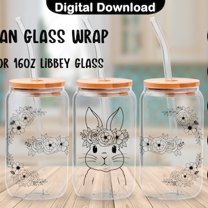 Op de afbeelding: Drie glazen potten van 473 ml met bamboe deksels en rietjes. De potten hebben zwart-witte ontwerpen van een konijn met een bloemenkrans en bloemkransen. De potten staan op een houten oppervlak.  SVG-, PNG-, PDF-, DXF- en EPS-bestandsformaten zijn vermeld.