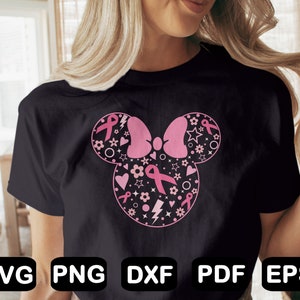 May include: A black t-shirt with a pink and white design of a Mickey Mouse head with a bow. The design is filled with pink ribbons, hearts, stars, and flowers. The text "SVG PNG DXF PDF EPS" is at the bottom of the image.
