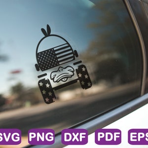 May include: Black and white silhouette of a jeep with an American flag on the bonnet and stars on the tyres. The jeep is on a white car window.