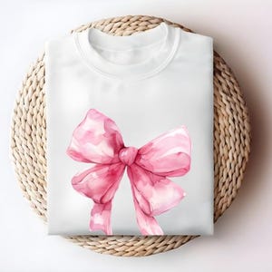 2025 Pink Bow Graphic T-Shirt for Women Stylish Bow Design Cute Tee Perfect for Casual Wear Gift for Her Trendy Feminine Fashion Top