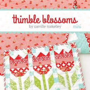 May include: A mini quilt with three red tulip designs, green stems, and blue and white accents. The quilt is bordered with red and white stripes. The text "thimble blossoms" and "Vintage Tulips" are displayed.