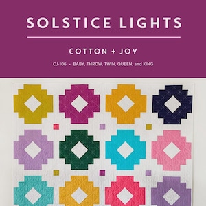 May include: A colorful quilt with a geometric pattern. The quilt features a repeating design of flower-like shapes in various colors, including yellow, pink, blue, and purple, set against a white background. The text "SOLSTICE LIGHTS" and "COTTON + JOY" is visible.