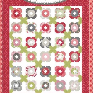 May include: A quilt pattern called "Blossomville" from the Coriander Quilts collection by Corey Yoder. The quilt features a white background with a repeating pattern of red, green, pink, and gray floral shapes.