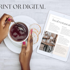 May include: A white tablet with a list of local restaurants. The tablet is on a wooden table with a cup of tea and cookies.