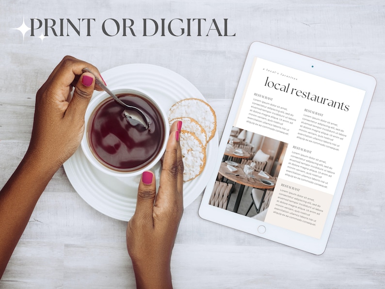 May include: A white tablet with a list of local restaurants. The tablet is on a wooden table with a cup of tea and cookies.