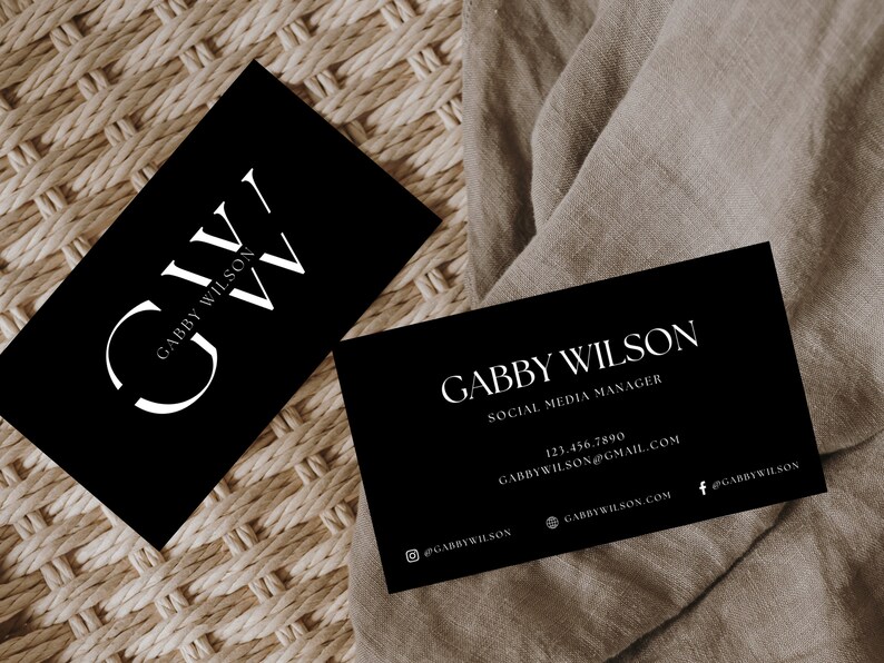 May include: Black and white business card with the name Gabby Wilson and the title Social Media Manager. The card also includes contact information such as a phone number, email address, and social media handles.