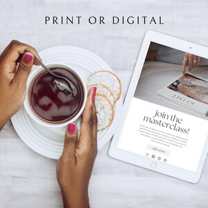 May include: A white tablet computer displaying a website with the text "join the masterclass!" and a call to action button. The website is promoting a digital or print masterclass. The tablet is on a white wooden surface with a cup of tea and biscuits.