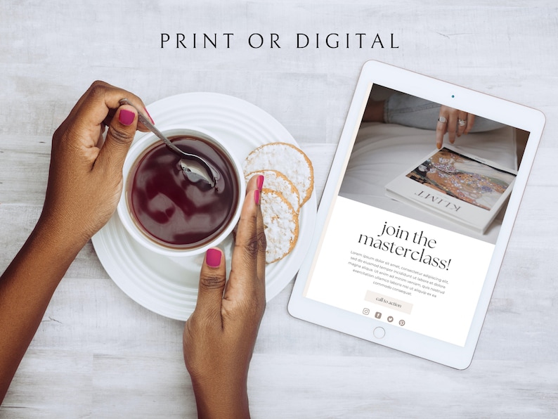 May include: A white tablet computer displaying a website with the text "join the masterclass!" and a call to action button. The website is promoting a digital or print masterclass. The tablet is on a white wooden surface with a cup of tea and biscuits.