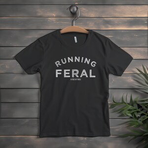 May include: Black t-shirt with white text that reads "Running Feral" and "A Fuss of Foxes".
