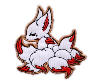 May include: White embroidered patch of a fox with nine red and gold tails. The fox is sitting with its head tilted down. The patch is 3 inches by 2.75 inches.