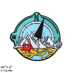 May include: Embroidered patch featuring a compass with a mountain range and a red tent. The compass needle points north. The patch is 3.25 inches by 3 inches.