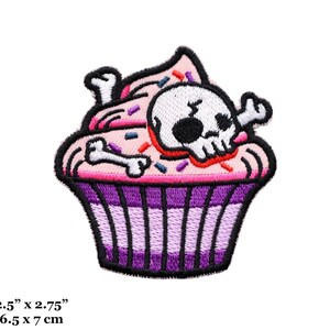 May include: Pink and purple embroidered cupcake patch with a white skull and crossbones inside. The cupcake has pink frosting and colorful sprinkles. The patch measures 2.5 inches by 2.75 inches.