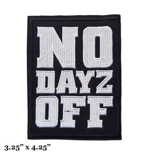 May include: Black embroidered patch with white lettering that reads "NO DAYZ OFF". The patch is 3.25 inches by 4.25 inches and 8 by 10 centimeters.