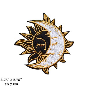 May include: Gold embroidered sun and moon patch with a black background. The sun has a stylized face with closed eyes and the moon has a stylized face with closed eyes. The patch is 2.75 inches by 2.75 inches or 7 cm by 7 cm.