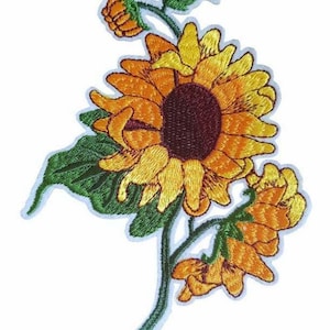 May include: Embroidered iron-on patch featuring a yellow sunflower with green leaves and orange buds. The patch measures 3.5 inches by 5 inches, or 9 cm by 13 cm.