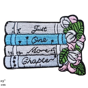 May include: Embroidered iron-on patch featuring a stack of books with the words "Just One More Chapter" and a floral design with pink and green accents. The patch measures 7.5 cm by 6 cm.