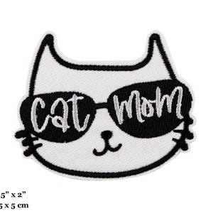 May include: White cat with black sunglasses and the text "Cat Mom" in silver embroidery. The patch is 6.5 cm by 5 cm.