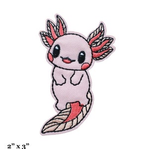 May include: Embroidered patch featuring a pink axolotl with black eyes, red gills, and a smiling mouth. The patch measures 2 inches by 3 inches. The axolotl has a detailed design and is ready to be ironed on to fabric.