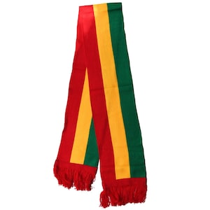 May include: A red, yellow, and green striped scarf with red fringe on the ends.