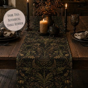 May include: A dark fall botanical table runner featuring a detailed pattern of leaves, ferns, and flowers in shades of green, gold, and brown on a black background. The text "DARK FALL BOTANICAL TABLE RUNNER" is printed in a circular overlay on the image.