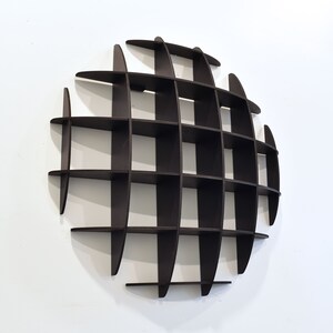 May include: A dark brown, circular wall shelf with a grid pattern. The shelf is made of wood and has a modern design.