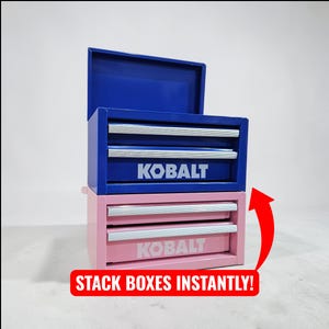 May include: Two-tiered tool chest in blue and pink, with the top chest open. Each chest has two drawers with silver handles and the "KOBALT" logo. The bottom chest is pink, and the top chest is blue. Text on the bottom reads "STACK BOXES INSTANTLY!"