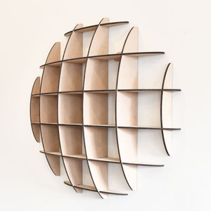May include: A wooden wall shelf shaped like a globe with multiple compartments. The shelf is made of light brown wood with black edges.